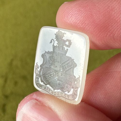 Detailed heraldic chalcedony intaglio with carving of a lion in a crown as the crest, with a griffin in the shield and Latin motto meaning Understanding is greater than fate