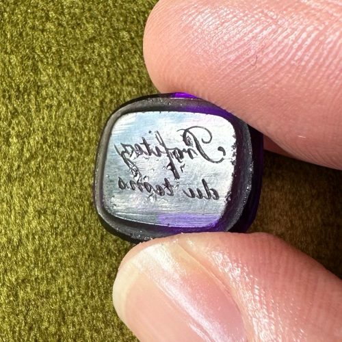 Purple paste intaglio with bevelled back Inscription in old French reads Profitez du tems, which literally means ‘Enjoy the time’ or less literally, ‘Make good use of your time’