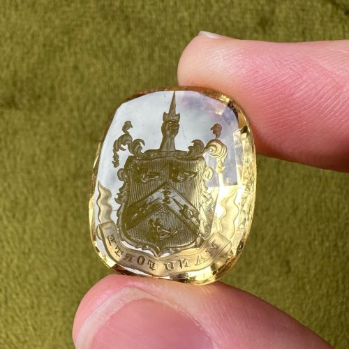 Large citrine intaglio with deep facet backwith imagery of an heraldic crest with three muzzled bears and two hands holding daggers pointing towards a roebuck’s head – crest is topped with a hand holding a dagger pointing skywards - Latin motto reads manu forte (strong hand)