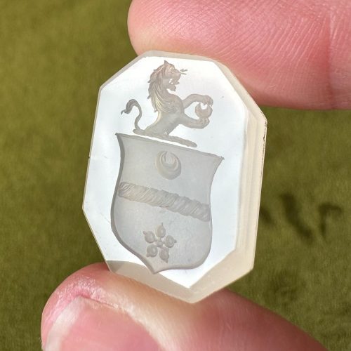 Georgian octagon chalcedony intaglio with image of a lion holding a crescent on top of a shield, with another crescent within the shield