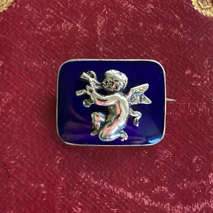 Silver enamel cherub brooch