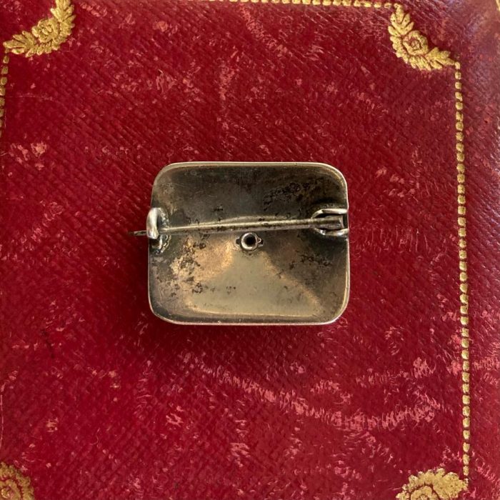 Silver enamel cherub brooch from back