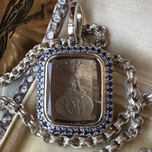 Platinum set intaglio seal pendant with sapphire and diamond bezel