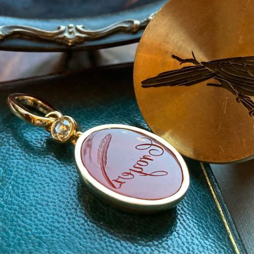 Gold dangle intaglio seal pendant with inscription Croyez and quill