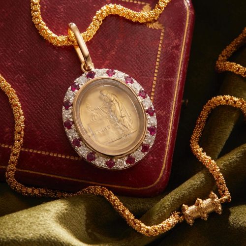 Gold set intaglio seal pendant with a ruby and diamon bezel