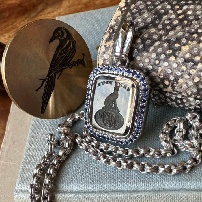 Platinum set intaglio seal pendant with a sapphire and diamond bezel