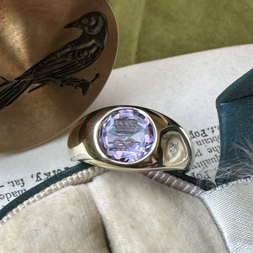 Close up of rubover intaglio seal ring in box