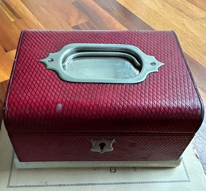 Red leather jewellery box with silver detail on lid