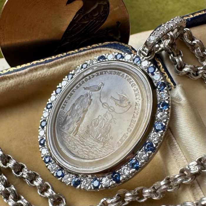 Platinum set classic intaglio seal pendant with sapphire diamond bezel